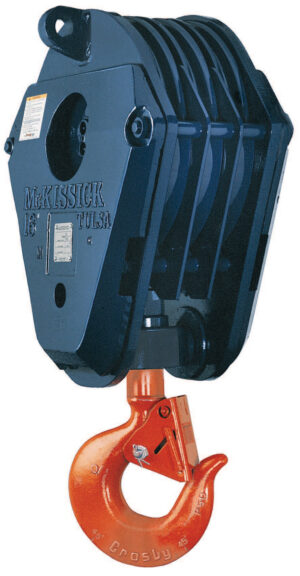 Industrial lifting block with an orange hook, labeled McKissick 16 Tulsa for heavy-duty use.