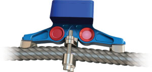 Blue clamp securing a steel cable, featuring bolts and red components for industrial applications.
