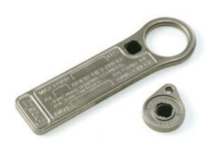 Metal tools with circular openings and engraved text on white background.