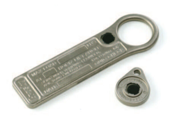 Metal tools with circular openings and engraved text on white background.